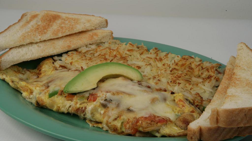 Mushroom & Cheese Omelette · Hearty omelette stuffed with mushrooms, bell peppers, onion, tomato and shredded jack cheese. Topped with a fresh slice of avocado and shredded jack cheese.