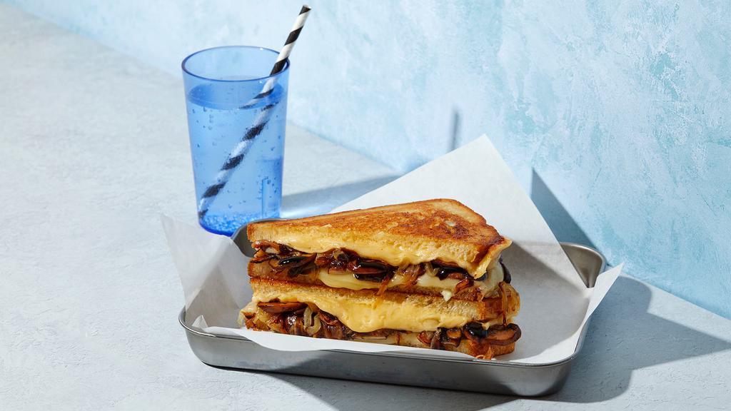 The Mushroom · Melted Swiss and Havarti cheese with roasted mushrooms, caramelized onions, balsamic and mayonnaise grilled between two slices of buttered bread.