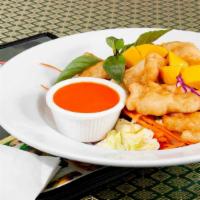 Mango Chicken · Crispy tempura chicken over with house mango sauce and sliced fresh mangoes. Served with ste...