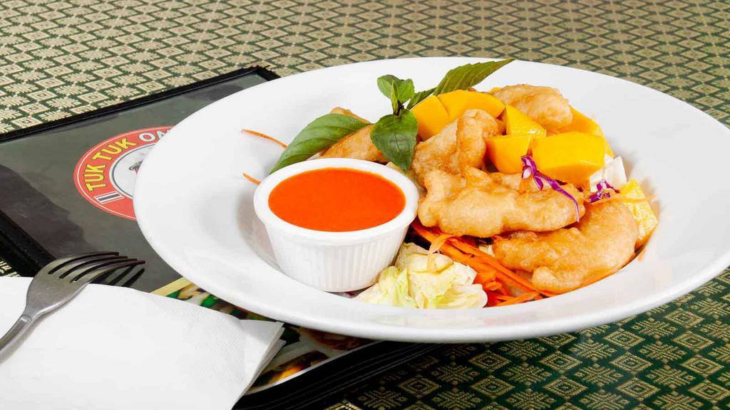 Mango Chicken · Crispy tempura chicken over with house mango sauce and sliced fresh mangoes. Served with steamed rice.