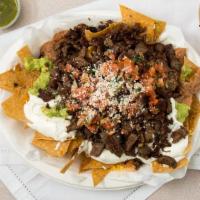 Super Nachos · With nacho cheese & Carne Asada.