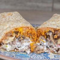 Carne Asada Burrito · Guacamole sour cream cheese rice beans and salsa.