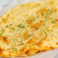 Garlic Naan · Leavened flour bread garnished with garlic.