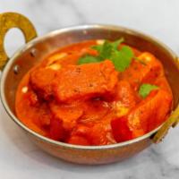 Chicken Tikka Masala · Chicken cooked in a tomato based creamy sauce.