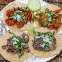 Tacos · Meat of choice, cilantro, onions, salsa in corn tortilla.