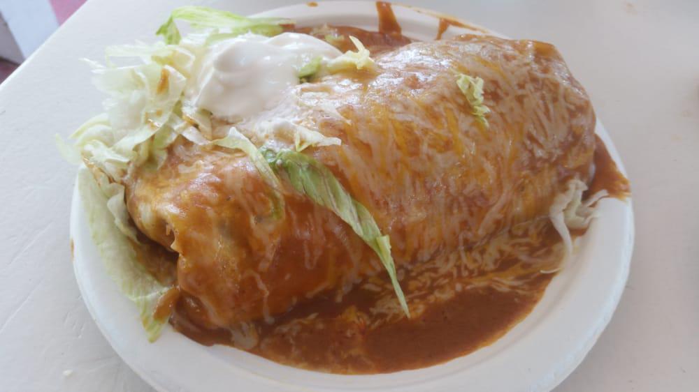 Wet Burrito · Choice of meat, rice, beans, cheese, onion, cilantro, salsa + wet sauce (sour cream and lettuce on top)