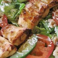 Chicken Salad · A Combination of Romaine Lettuce, Tomatoes, Cucumbers, Walnuts, Feta Cheese, Topped with Chi...