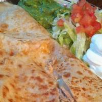 Quesadilla · A grilled flour tortilla filled with monterey jack cheese, served with guacamole and sour cr...