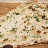 Garlic Naan · Leavened tandoor oven baked flat bread topped with garlic and cilantro.