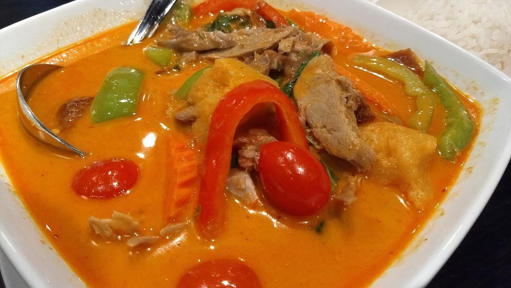 Siam Neramid · Special curry with grill duck, comes with baby tomato pineapple, bell peppers, carrot, and basil leaves.