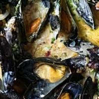 Mussels Mostarda · Fresh black mussels steamed with shallots, wine, mustard, and cream.