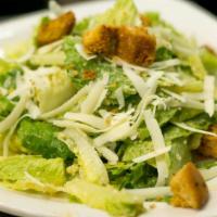 Caesar Salad · Romaine hearts tossed with our homemade garlic caesar dressing garnished with Parmesan, Roma...