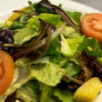 Dinner Salad · Radicchio, romaine, iceberg lettuce, tomatoes, oranges, and olives.