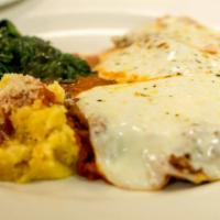 Veal Parmigiana · Served with spinach and choice of potatoes, polenta or pasta with meat sauce.
