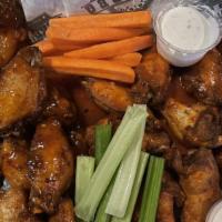 Jumbo Chicken Wings · Jumbo Bone In wings marinated overnight, slow cooked, then deep fried golden brown and tosse...