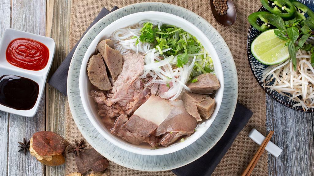 Phở Bò Đặc Biệt (She-Bang) · The whole shebang of tender brisket, fine rib-eye slices and juicy beef tendon balls; served in our 12-hour bone broth