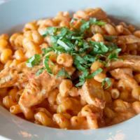 Pasta Rossa · Corkscrew pasta blended with parmesan, alfredo, and marinara with chicken, and topped with f...