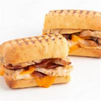 Turkey Melt Panini · Roasted turkey, bacon, cheddar cheese, and rustic Thousand Island Dressing. Served on grille...