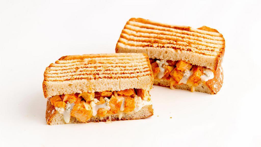 Buffalo Chicken Panini · Chicken, provolone cheese, and spicy buffalo sauce with blue cheese dressing. Served on grilled sourdough bread.