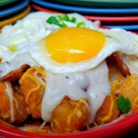 Tater Tot Nachos · Tater tots pilled high and smothered in cheese and chili, topped w sour cream, salsa, guacam...