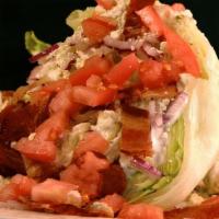 Iceberg Wedge Salad · Wedge of iceberg lettuce topped with creamy bleu cheese dressing, fresh diced tomatoes, red ...