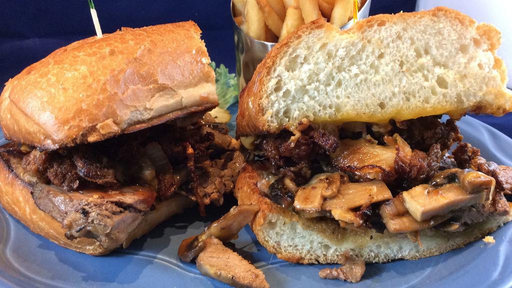 Smoke House Tri Tip · Fresh roasted tri tip with melted cheddar cheese, mushrooms and BBQ sauce topped with house made onion strings on a roll.