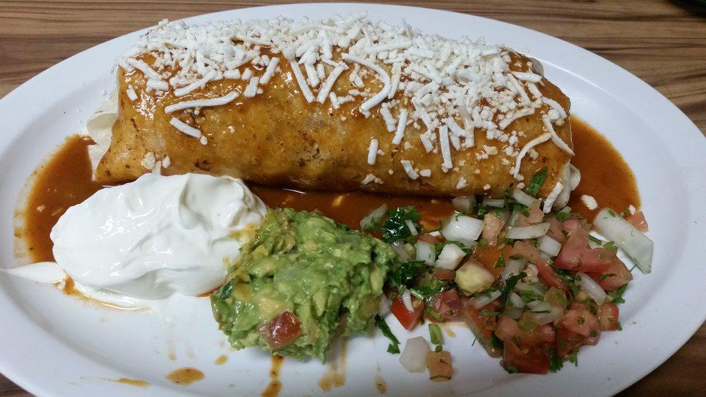 Wet Burrito · Burrito filled with rice, beans, pico de gallo and your choice of meat - covered in red sauce and melted cheese. Served with sour cream, guacamole, lettuce, and pico de gallo.