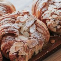 Almond Croissant · Flaky buttery and melt in your mouth croissant stuffed with almond cream and topped with sli...