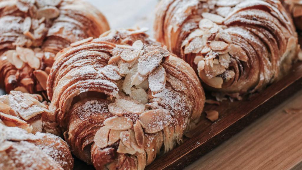 Almond Croissant · Flaky buttery and melt in your mouth croissant stuffed with almond cream and topped with sliced almonds.