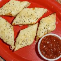 Garlic Cheese Bread · Five pieces of homemade garlic cheese bread with a side of marinara sauce.