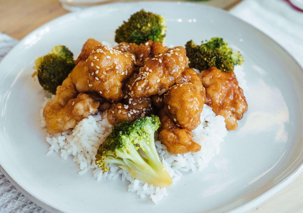 Sesame Chicken · Tender fried chicken chunks topped with a rich garlic sauce and fresh sesame seeds.