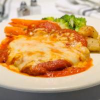 Pollo Parmigiana · Breaded chicken breast topped with tomato sauce and melted mozzarella cheese, with a side of...