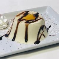 Panna Cotta · A traditional Italian cooked cream with vainilla beans served with hot fudge sauce and honey.