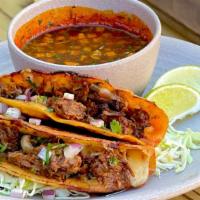 Birria Crusty Queso Tacos · Two crunchy, cheesy braised beef tacos on grilled crispy corn tortillas. Served with chile s...