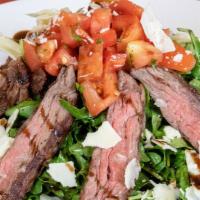 Steak Salad · Skirt steak on arugula, marinated tomatoes, shaved parmesan and balsamic vinaigrette.