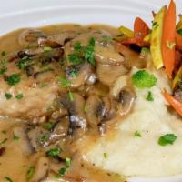 Chicken Marsala · Sautéed mushrooms in a marsala cream sauce served with mashed potatoes and mixed vegetables.