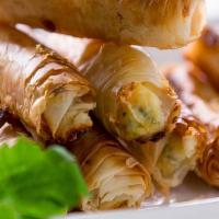 Cheese Burek · Four pieces of fried cheese filled pastries made of a thin flaky dough such as phyllo or yuf...