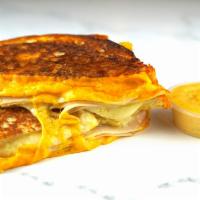 Roasted Turkey & Cheese Monte Cristo · Roasted turkey breast, Cheddar, Swiss, and Parmesan cheeses melted between egg dipped, gridd...