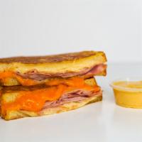 Smoked Ham And Cheese Monte Cristo · Smoked ham, Cheddar, Swiss, and Parmesan cheeses melted between egg dipped, griddled sourdou...
