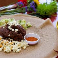 Kitfo Dulet (Cooked Or Raw) · Lean, tender beef seasoned with garlic, jalapeño, mitmita, onion, and spiced butter
