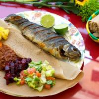 Whole Trout Fish · Fried Whole trout fish seasoned with house special spices and served with 4 vegan sides