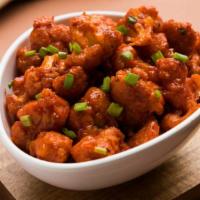Gobi Manchurian · Crispy, coated cauliflower tossed with herbs and spices.