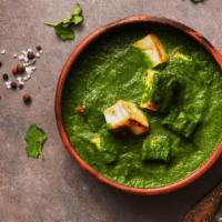Saag Paneer · Fresh spinach cooked with herbs and spices with homemade cheese cubes.