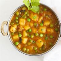 Aloo Mattar · Delicious potatoes and green peas cooked in sauce.