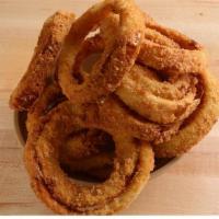 Onion Rings · Our hand-dipped breaded onion rings, fried to a crisp, golden brown. Served with ranch dress...