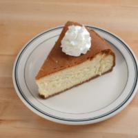 New York Cheesecake · A cut of our traditional rich and creamy New York style cheesecake with a crumbling graham c...