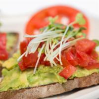 Avocado Toast · Smashed avocado, chopped tomatoes, sprouts, fresh herbs, and cracked lemon pepper on buckwhe...