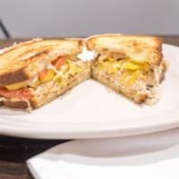 Spicy Tuna Melt Sandwich · Albacore tuna salad, melted swiss cheese, banana, peppers and sliced tomatoes on grilled rus...
