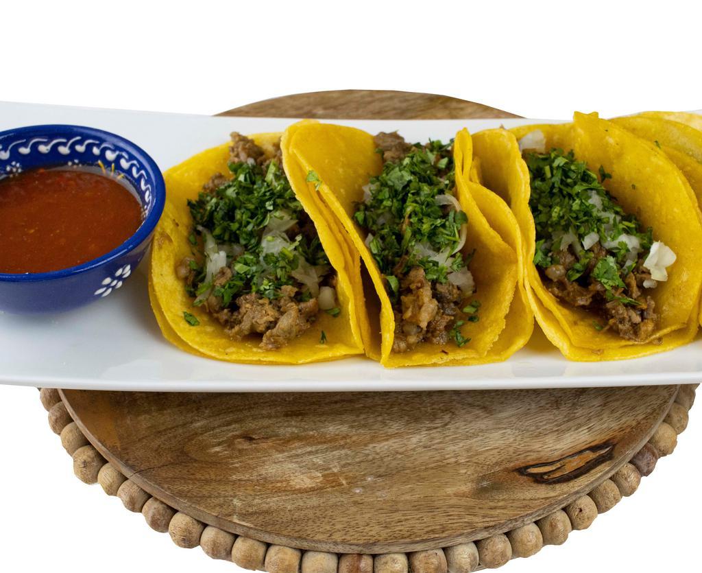 4 Street Taco Dinner · 4 mini tortillas filled with carne asada topped with chopped onions, cilantro, and red salsa. Served with rice and beans.