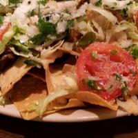 Nachos · Corn tortilla chips, spread with refried pinto beans, topped with melted cheese, pico de gal...